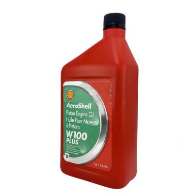 Red plastic bottle of AeroShell Oil W100 Plus piston engine oil with a green label, featuring the Shell logo and product details. The bottle is positioned upright against a white background.
