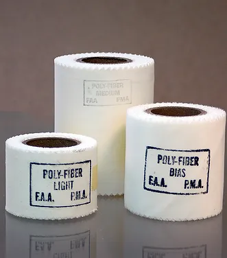Three rolls of tape labeled "Poly-Fiber Light" and "Poly-Fiber Bias" are displayed on a neutral background. The rolls vary in size, with the largest in the back and the two smaller rolls in front. The product is titled "Bias Cut Finishing Tape."