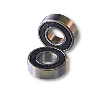 Two metal ball bearings are shown, one positioned upright and the other lying flat. Both have a black rubber seal around the outer edge. The image is related to "Azusa Axles & Bearings," highlighting components used in mechanical applications.