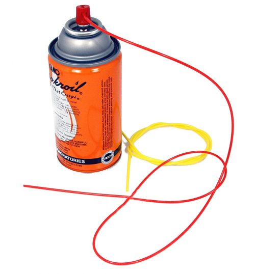 Orange aerosol can with a red nozzle and attached red and yellow flexible tubes, part of the "AIM-A-SQUIRT PRECISION AEROSOL TOOL" for targeted spraying.