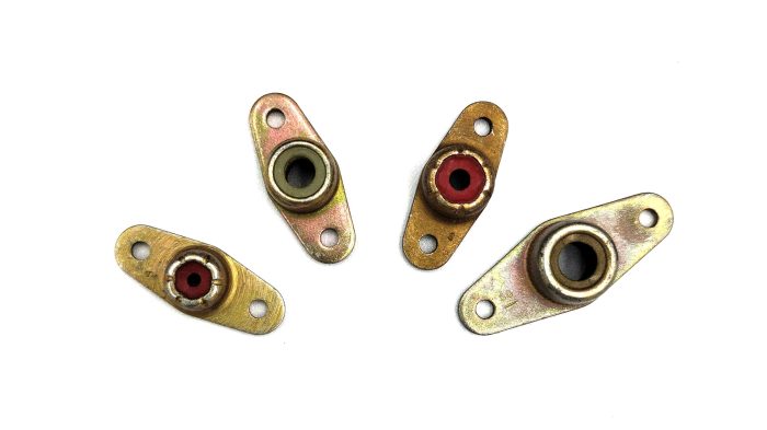 Four Anchor Nut Two Lug (AN366) fasteners are displayed against a white background. Each nut has two mounting holes and a central threaded section, with varying metal finishes.