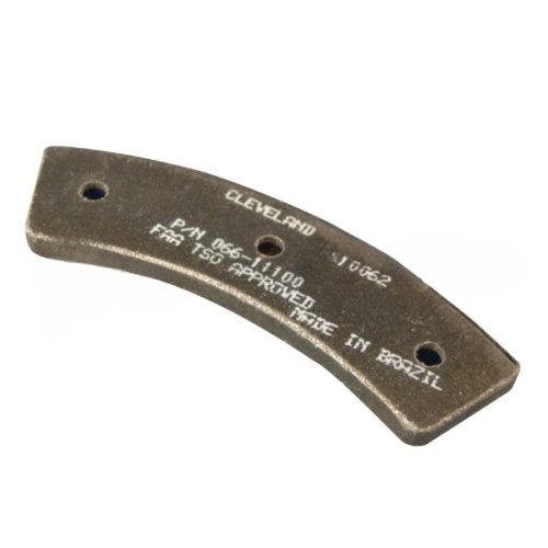 Cleveland Brake Lining, a curved metal component with two holes for mounting, features text indicating its model number and approval status. It is labeled "Made in Brazil" and is designed for use in automotive applications.