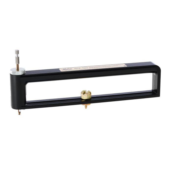 Image of a hole cutter featuring a rectangular black frame with an adjustable brass knob and a drill bit attachment on one end. Designed for precision cutting, suitable for various materials.