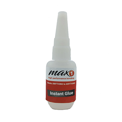 A small white bottle of Max 1 Instant Glue Adhesive with a red label, featuring a pointed nozzle. The label reads "Binds ANYTHING to ANYTHING" and "Instant Glue," highlighting its high-performance bonding capability.