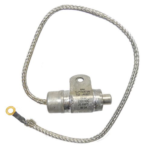 Ignition Filter Capacitor with a cylindrical metal body, a threaded end, and a wire lead attached. The wire features a ring terminal for connection. The capacitor is labeled with specifications, including voltage and amperage ratings.