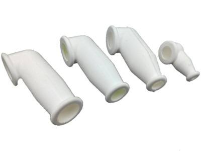 Four white electrical terminal nipples of varying sizes are arranged in a row on a plain background, showcasing their angled design and open ends.