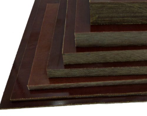 Stacked sheets of brown laminated phenolic material in varying thicknesses, arranged in a descending order from largest to smallest.