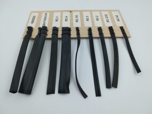 A display board featuring various types of rubber channels, each labeled with a code. The channels vary in width and design, showcasing different styles and applications.