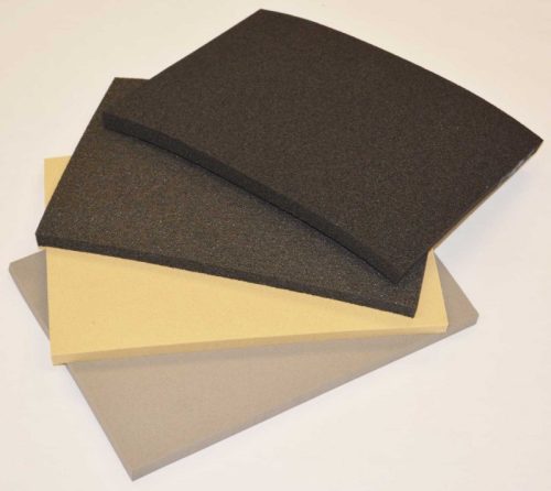 Three pieces of soundproofing foam in varying colors: one black, one beige, and one gray. The foam is flat with a slight curve on the top of the black piece, showcasing different textures and thicknesses suitable for noise reduction applications.