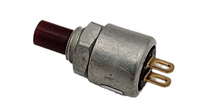 Image of a Sub Miniature Momentary Switch with a red push button. The switch has a metal casing and two gold connectors, designed for temporary electrical connections.