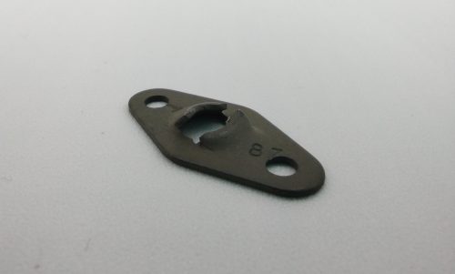 Image of an "Anchor Type Speed Nut Flat," a metal fastener with a central raised section and two holes on either end, lying on a plain surface.
