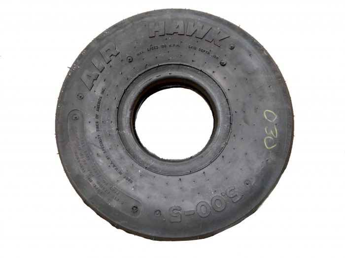 A black Aerotrainer/Air Hawk tire with visible tread pattern and embossed branding. The tire is circular and has a smooth surface, suitable for various applications.