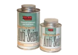 Two cans of Non Metallic Anti-Seize Lubricant are shown, one larger and one smaller, with green labels and screw-top lids. The brand name is visible at the top of each label.