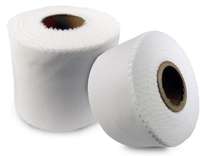 Two rolls of white bias pinked tape, one standing upright and the other lying on its side, showing the textured edges.