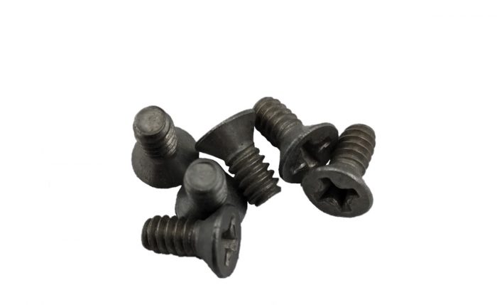 A group of six black 82-degree countersink machine screws with flat heads and threaded bodies, arranged on a white background.