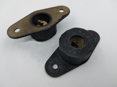 Two black cowl mounts with metal inserts and bolt holes, positioned on a white background.