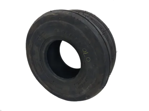 Black Carlisle Tire displayed upright, showcasing its round shape and tread pattern. The tire has a central hole and is designed for durability and performance in various applications.