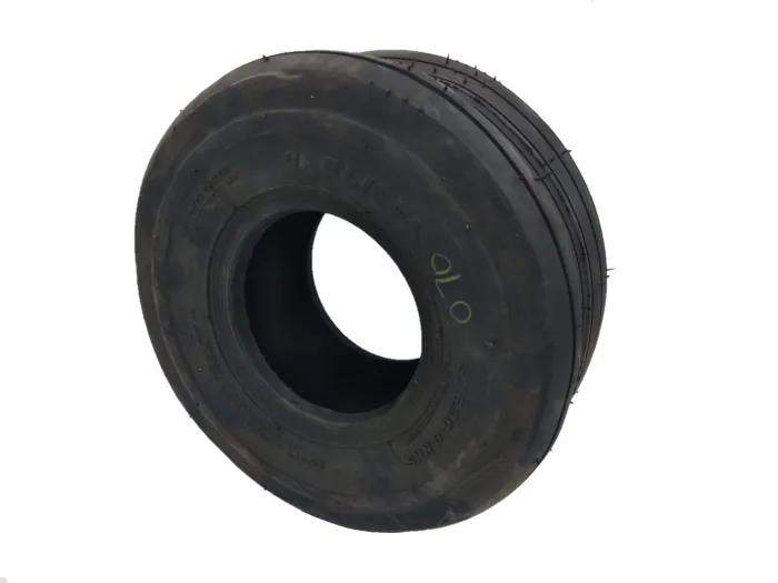 Black Carlisle Tire displayed upright, showcasing its round shape and tread pattern. The tire has a central hole and is designed for durability and performance in various applications.