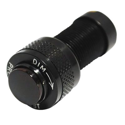 A black cylindrical "Amber LED Press to Test" indicator with a textured grip and labeled "DIM" with an arrow. The button is prominent, designed for testing purposes.