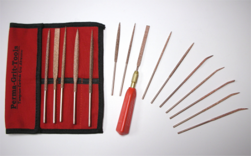 A set of Perma-Grit Needle Files displayed with a red tool pouch on the left. The files have various shapes and are arranged beside a red-handled tool. The pouch is labeled "Perma-Grit Tools."