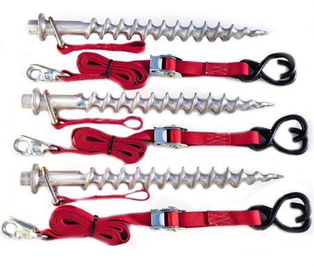 Four metal screw anchors with red straps and black hooks, part of the Big Screw EZ Tie-Down System, are arranged horizontally. Each screw has a metal loop and a clip for securing items.