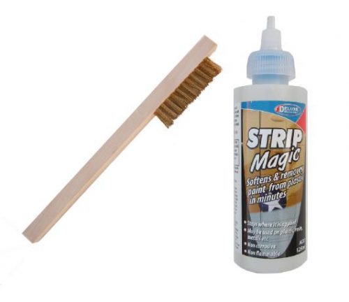 A Permagrit Cleaning Kit featuring a small wooden brush with bristles and a bottle of Strip Magic solution.