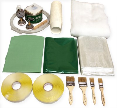 Vacuum Bagging Composite Starter Kit with Fiber Glass Cloth includes green sheets, fiber glass cloth, brushes, tape rolls, a gauge, and a roll of white material, arranged on a surface.