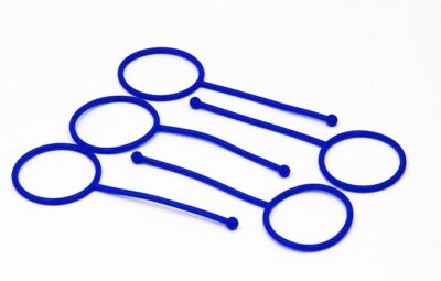 Blue Hold-It Aerosol Straw Holders are shown. They consist of circular loops connected to narrow bands, designed to secure aerosol straws in place.