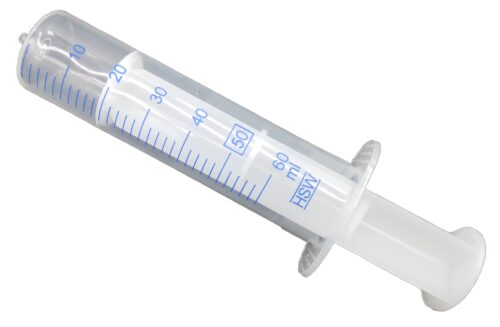 Close-up image of a TCP Fuel Treatment Dispenser, resembling a syringe with measurement markings. The dispenser is transparent, allowing visibility of the liquid level inside.