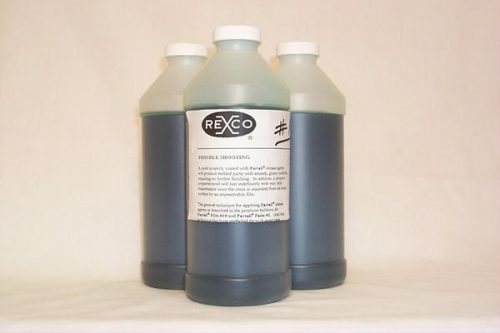 Three bottles of Rexco mold release agent with white caps and dark liquid inside. The front bottle displays a label with the Rexco logo and product details.