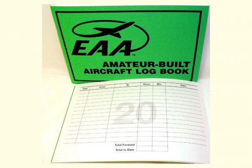 Green cover of an EAA Amateur-Built Aircraft Log Book with an open page showing a blank log sheet, including columns for recording flight details.