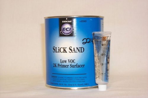 A blue can labeled "Slick Sand Low VOC 2K Primer Surfacer" is next to a small tube with text on it. Both items are placed against a plain white background.