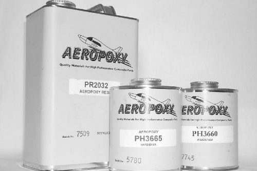 Three metal cans labeled "Aeropoxy" with different product numbers are displayed. The largest can is on the left, and two smaller cans are on the right. The background is plain.