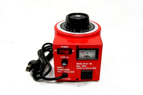 Red variable transformer with a black dial on top, a power switch, and a fuse indicator on the front. It has an analog meter display and a black power cord. Model details and voltage specifications are printed on the front panel.