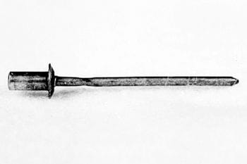 A metal tamping iron with a pointed end and a flat, cylindrical base, shown against a plain background.