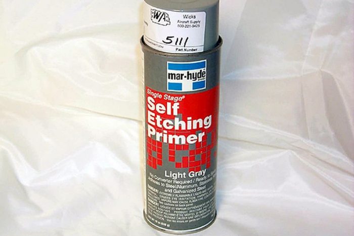 A can of mar-hyde Self Etching Primer in light gray, standing on a white surface. The can features a red label with white text and a gray cap.
