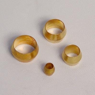 Four round, yellowish bamboo rings of varying sizes are placed on a white textured surface.
