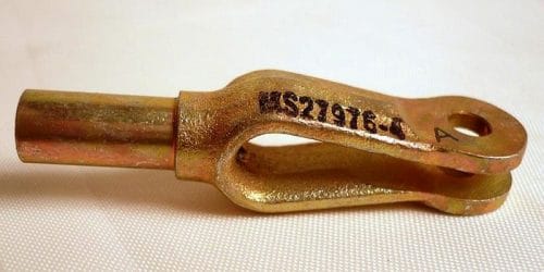 A metal clevis with a cylindrical end and a U-shaped fork, featuring a hole for a pin. It is marked with the code "MS21976-1" on the side. The clevis is placed on a light surface.