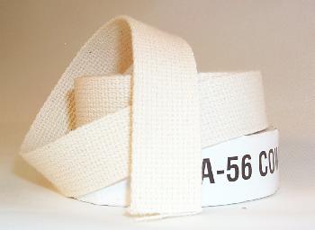 A roll of off-white cotton tape with a textured surface, partially unrolled and resting on a surface. A white label with black text is visible, wrapped around the tape.
