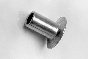 Metal doorstop mounted on a wall, with a cylindrical shape and a flat, circular base.