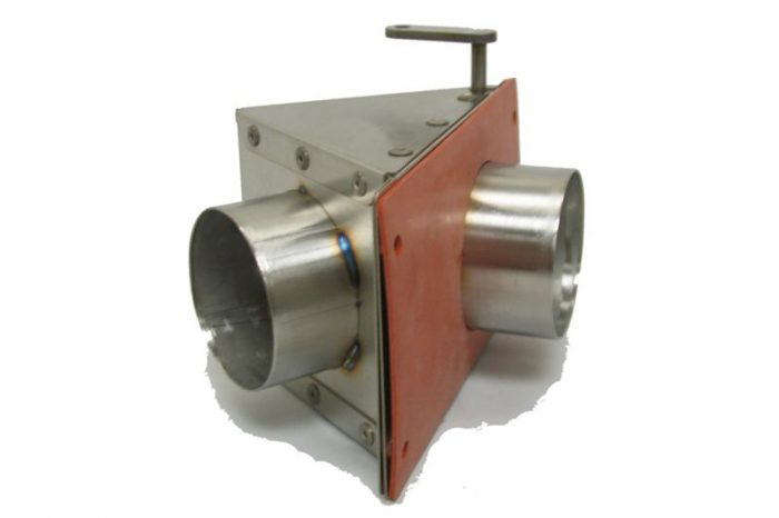 A metal industrial component with a triangular base and two cylindrical openings on opposite sides. It has a flat red panel on one side and a handle on top.
