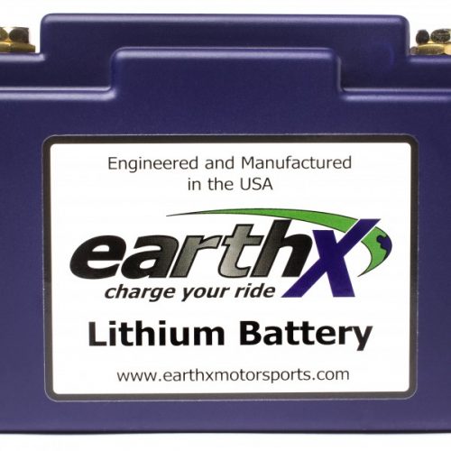 A blue lithium battery with a label reading "EarthX, charge your ride" and "Engineered and Manufactured in the USA." The website "www.earthxmotorsports.com" is also displayed on the label.