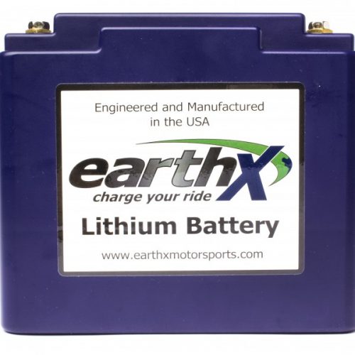 A blue EarthX lithium battery with a label reading "Engineered and Manufactured in the USA" and "charge your ride." The website "www.earthxmotorsports.com" is also displayed on the label.