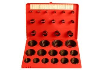 A red plastic case containing assorted black rubber O-rings organized by size in individual compartments. The lid is open, displaying additional slots for O-rings.