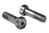 A black hex bolt and a gray hex nut are placed on a plain white surface. The bolt is oriented horizontally with visible threading, while the nut is upright, showing its hexagonal shape.
