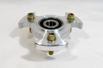 Silver metal hub with four protruding bolts and a central bearing, set against a plain white background.