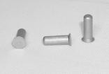 Three silver cylindrical rivets are displayed on a plain white surface, each positioned differently: one upright, one on its side, and one at an angle.