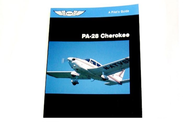 Cover of a pilot's guide titled "PA-28 Cherokee" featuring an image of a small aircraft in flight against a blue sky.