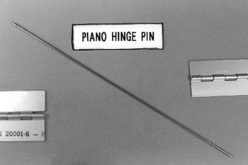 A long, thin piano hinge pin is displayed diagonally across the image, with two metal hinge pieces on either side. A label above reads "Piano Hinge Pin."