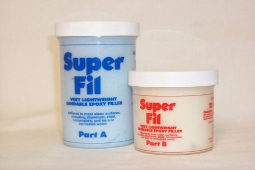 Two containers of Super Fil epoxy filler are shown. The larger container is labeled Part A and the smaller Part B. Both have white lids and are designed for lightweight variable epoxy filling.
